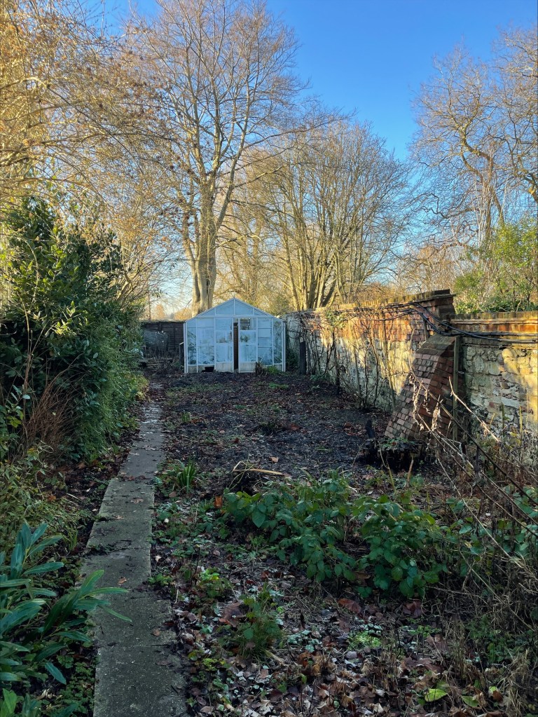 empty walled garden and greenhouse