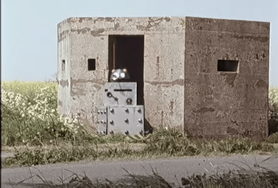 Still from Timelords video - home made dalek emerging from concrete pillbox